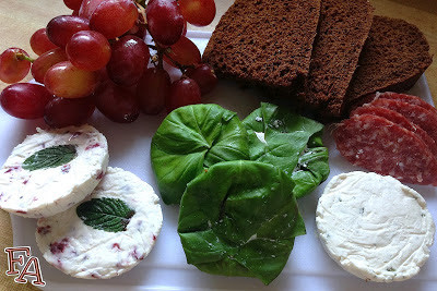 Goat cheese and other cheeses on wooden board