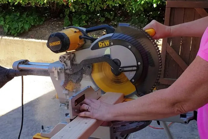 Cutting 2x4 board with miter saw for giant jenga game