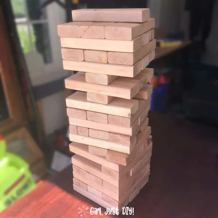 Giant jenga game being played with pieces removed
