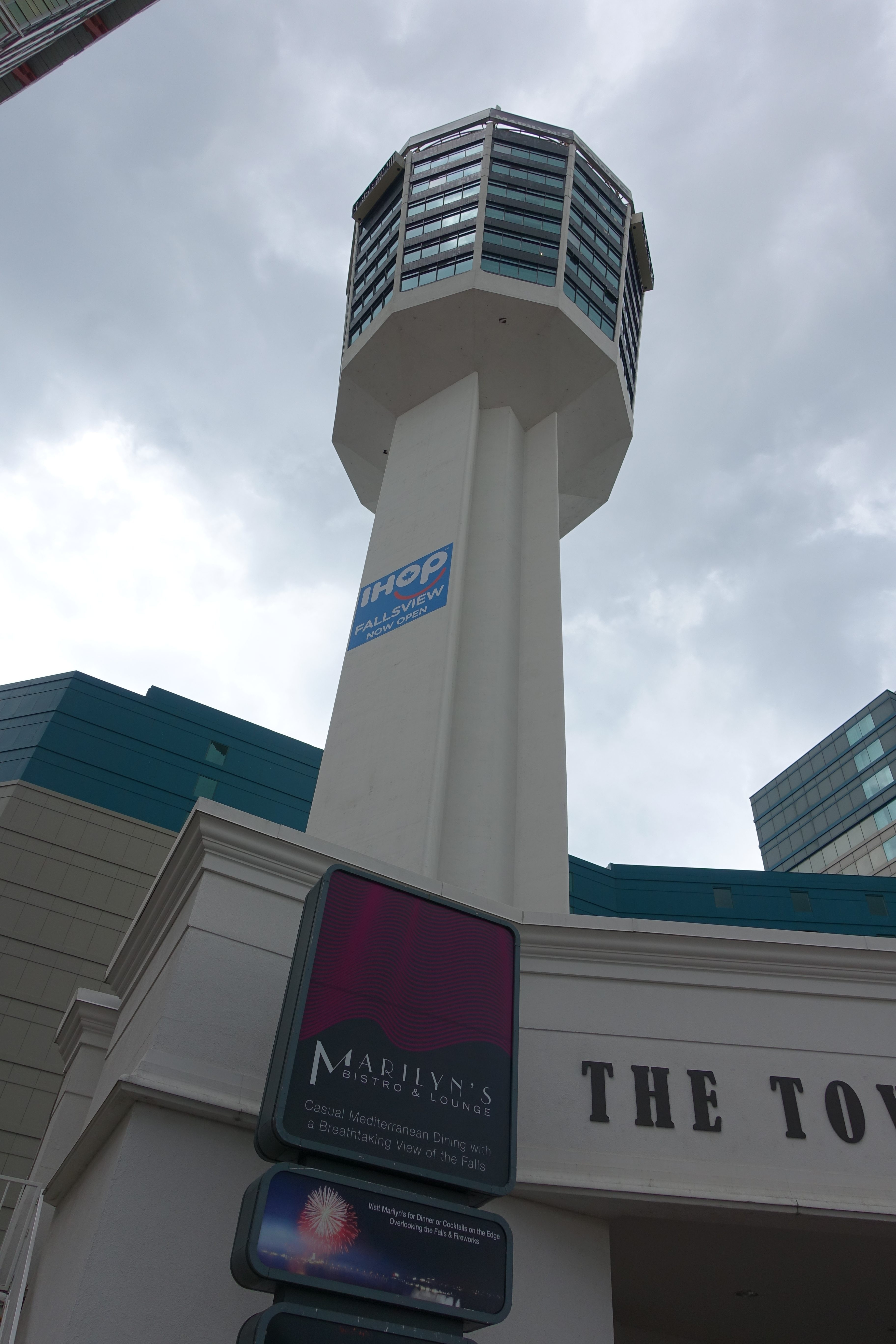 Sign listing attractions, including Galaxian 3, at the Minolta Tower in 1995