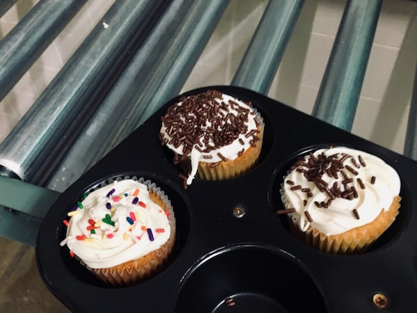 In-game: 3 decorated cupcakes in a baking pan.