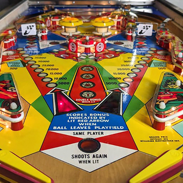 Solid State Pinball Supply alt: Inside Solid State Pinball Supply, a vibrant scene unfolds with numerous vintage pinball machines lined up, their colorful lights and designs creating an inviting atmosphere for gamers.