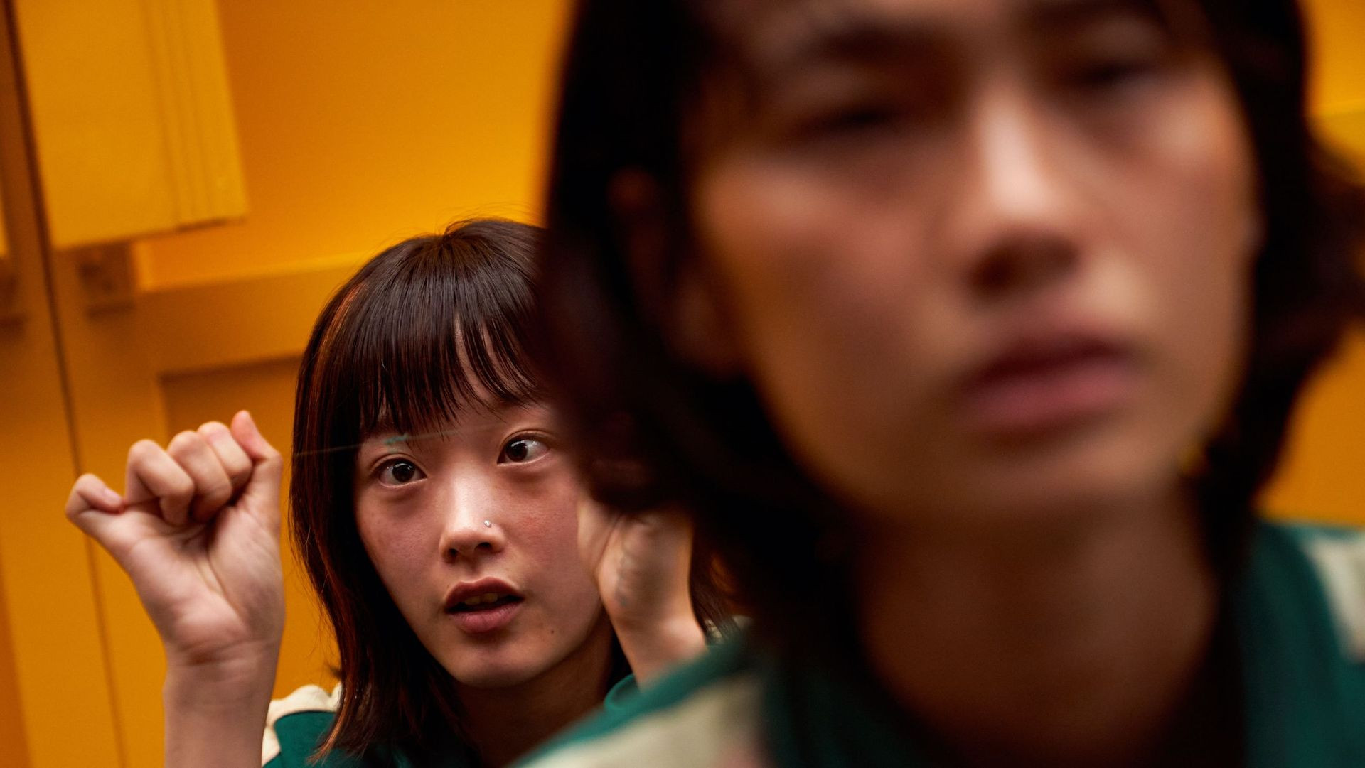 Lee You-mi as Ji-yeong, or player 240, holding up her hands by her face in a still from squid game season 1