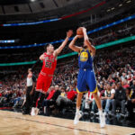 Klay Thompson sinking a NBA record 14 3 pointers in a 2018 game vs the Bulls, solidifying his place in basketball history and showcasing exceptional shooting skill