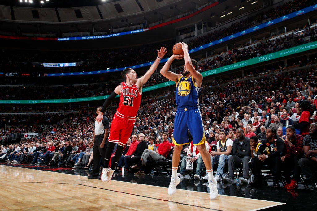 Klay Thompson sinking a NBA record 14 3 pointers in a 2018 game vs the Bulls, solidifying his place in basketball history and showcasing exceptional shooting skill