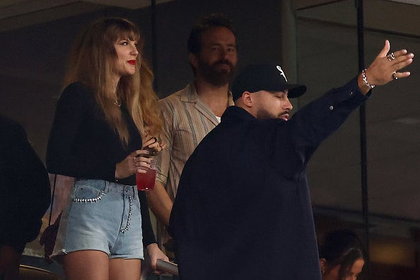 Taylor Swift and Ryan Reynolds watching the Jets game, Taylor wearing a neutral-toned outfit.