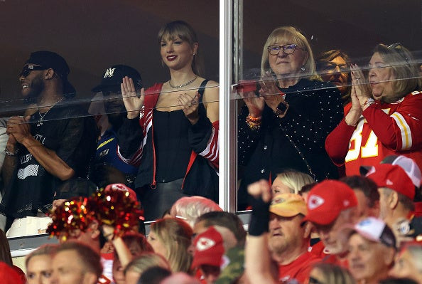 Taylor Swift cheering with Donna Kelce at the Broncos game, wearing a Chiefs jacket.