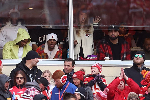 Taylor Swift watching the Bengals game, wearing a varsity jacket.