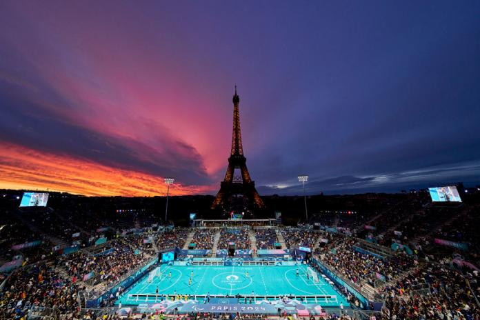 A view of the outdoor Paris 2024 blind football stadium at sunset, with the Eiffel Tower in the background, showcasing the Argentina games venue