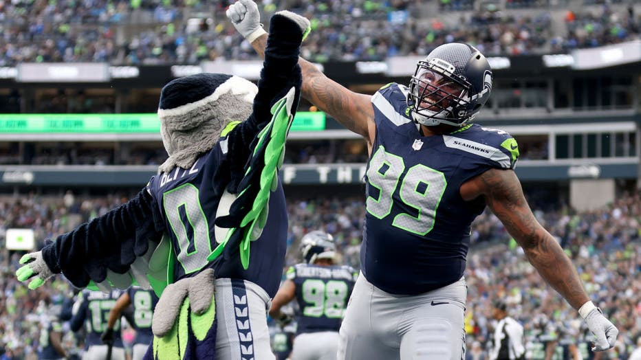 Leonard Williams #99 of the Seattle Seahawks celebrates against the Arizona Cardinals, showcasing the excitement of Seahawks game day.