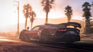 A red supercar racing along a palm tree lined street
