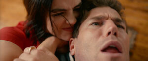 Lucy Hale as Lucy and Austin Stowell as Josh in The Hating Game, showcasing their on-screen chemistry and capturing the essence of their complicated relationship.