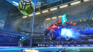 Rocket League screenshot of a red racing car with bright turbo boosters leaping through the air in a large closed roof arena.