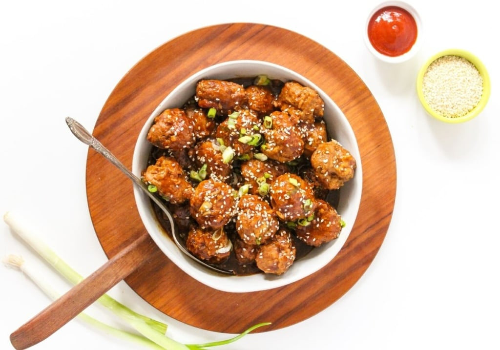 Crockpot honey sriracha meatballs in a large white bowl