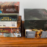 Game boxes stacked on top of each other, showcasing different designs and colors