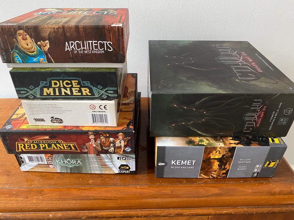 Game boxes stacked on top of each other, showcasing different designs and colors