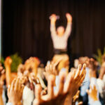 hands raised up at a conference