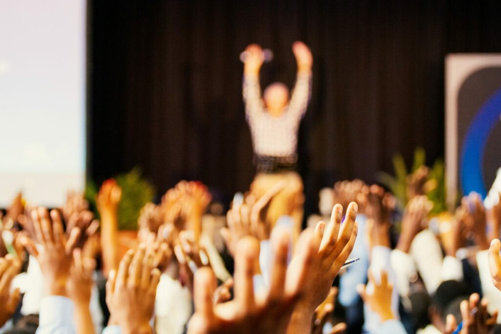 Hands raised up at a conference