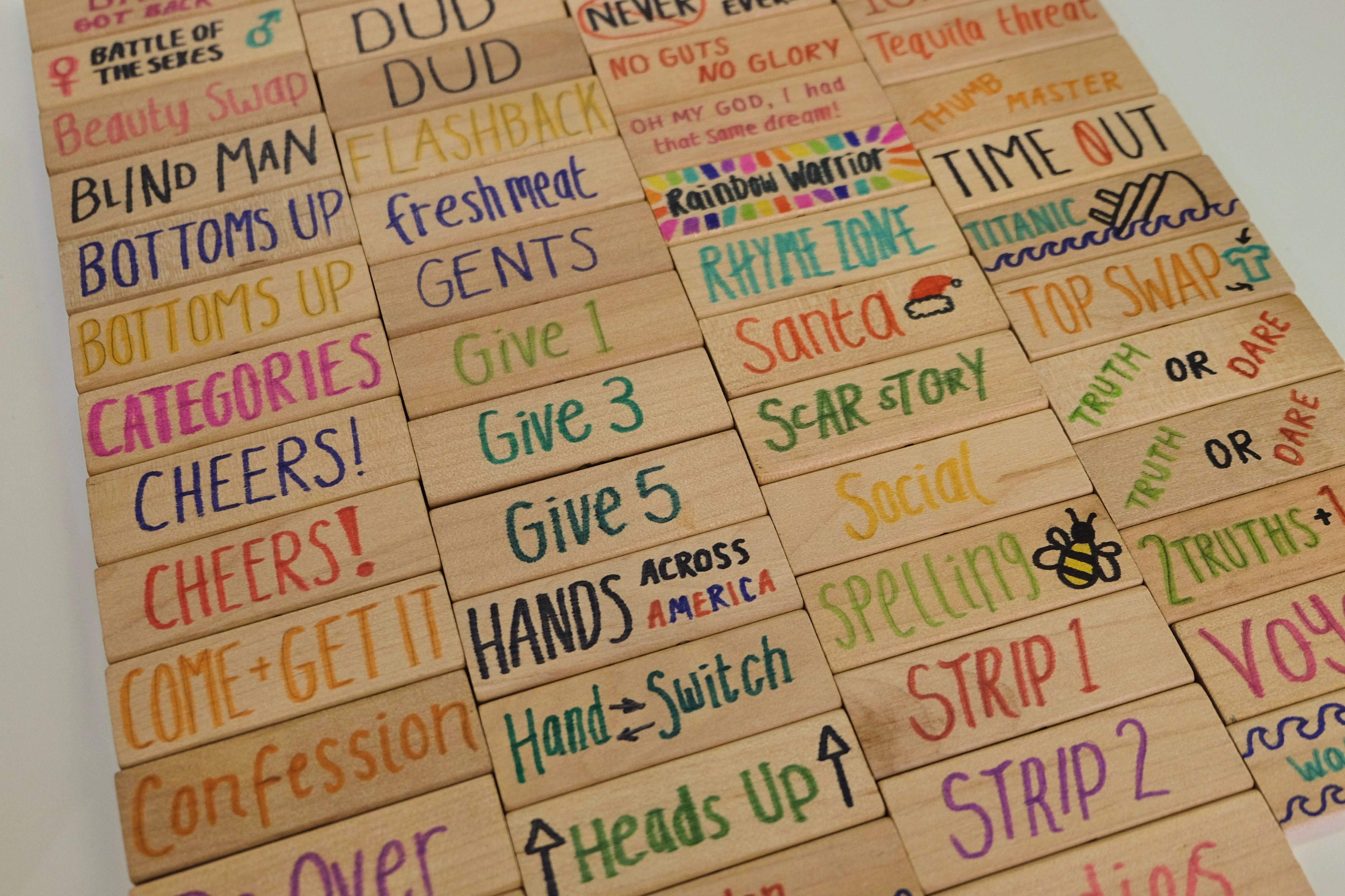 Close-up of Jenga blocks with drinking game rules