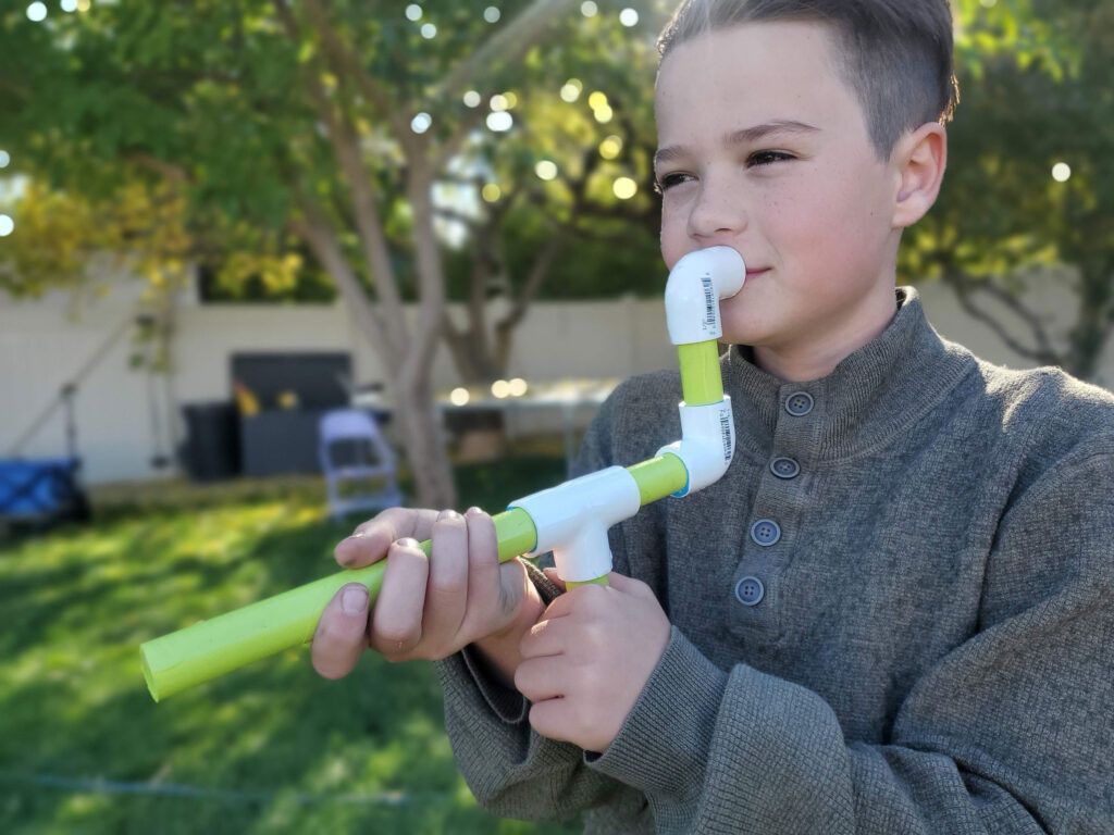 Boy holding a DIY marshmallow shooter
