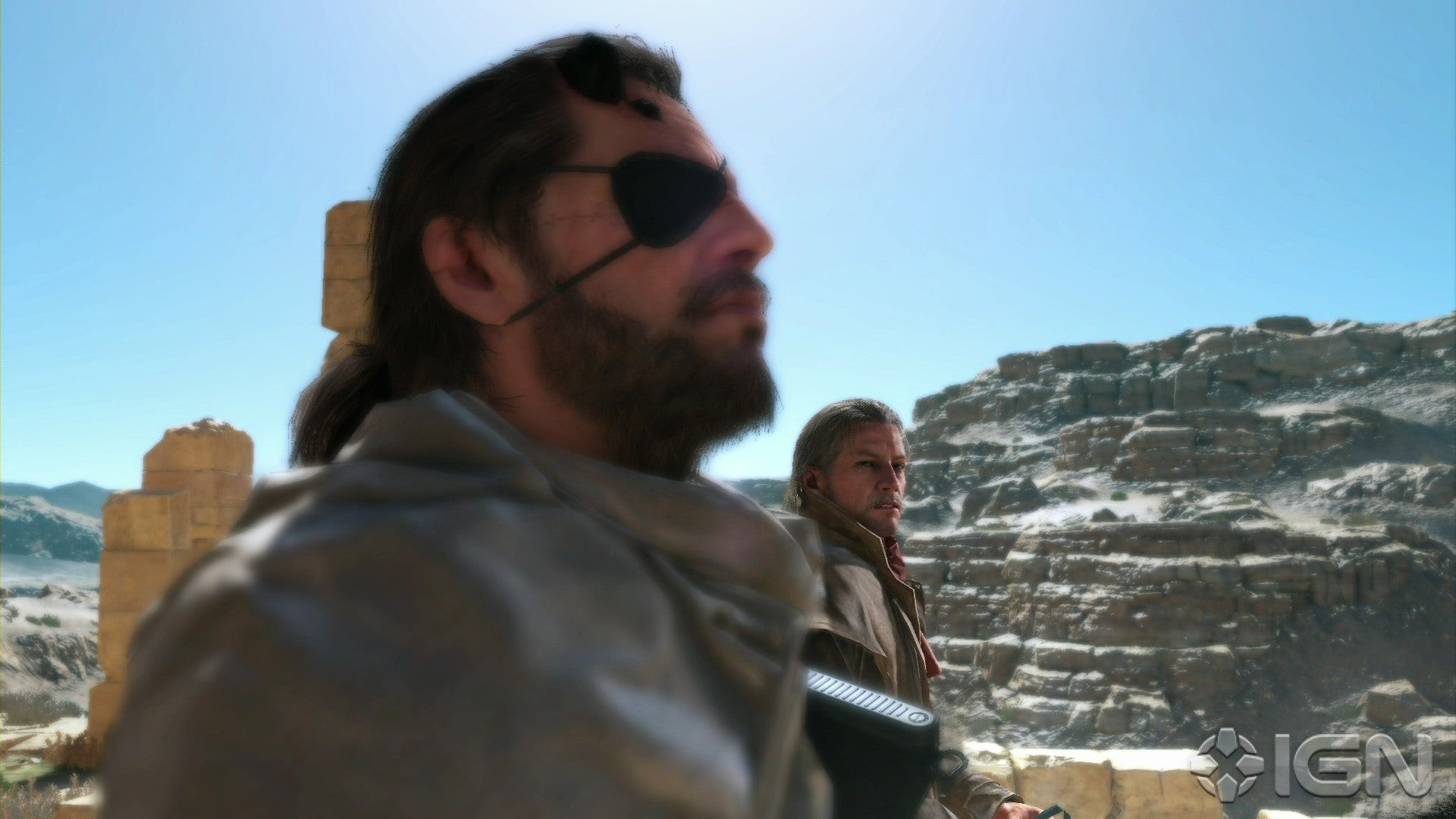 A man in an eyepatch and another man looks at him