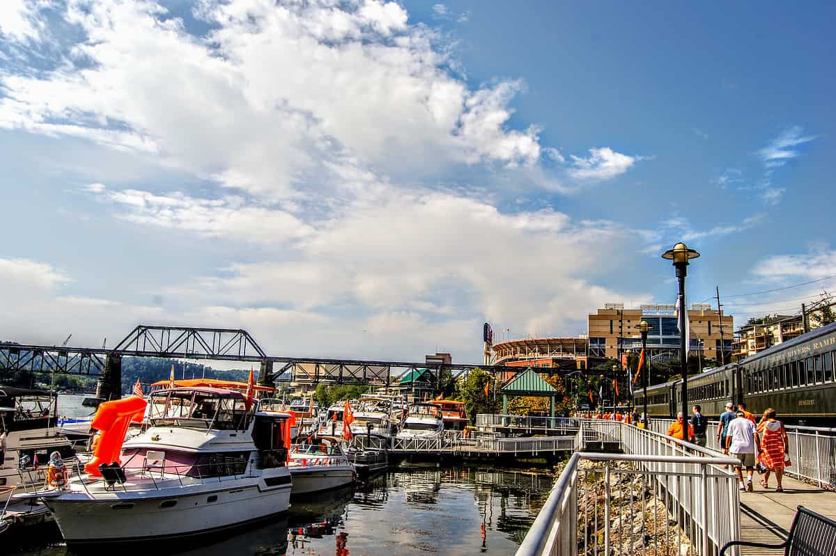 The Vol Navy is parked along the Neyland Greenway in downtown Knoxville, TN. Neyland Stadium and Thompson- Boling Arena are in the distance.