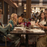 Four women sitting and talking in a restaurant.