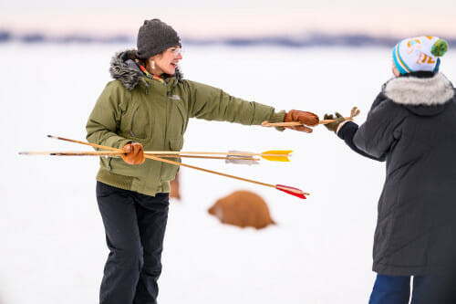 UW student Abby Sunde gathers spears at Ojibweg Bibooni-Ataadiiwin.