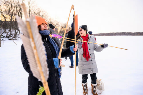 Diana Vera from the Otomi Tribe fits a spear onto an atlatl.