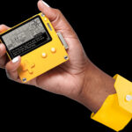 A close-up of a person's hands using a portable game system, focusing on the buttons and controls.