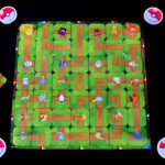 Pokémon Labyrinth setup with board, standees, tiles, and Poké Ball tokens