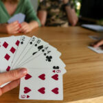Woman playing cards with friends