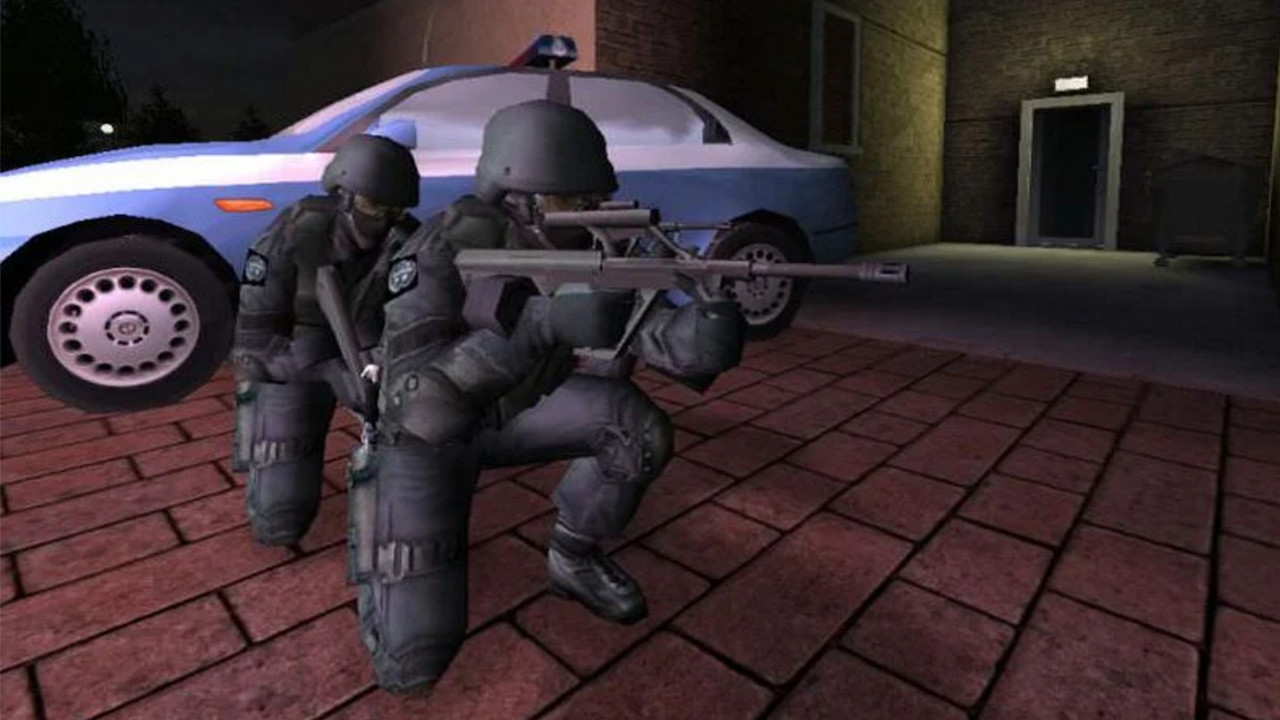Two soldiers kneel near a police car, one wields a rifle