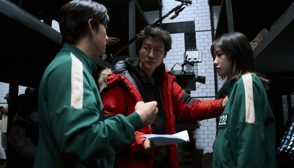 Yim Si-wan, Director Hwang Dong-hyuk, and Jo Yu-ri on the set of Squid Game Season 2