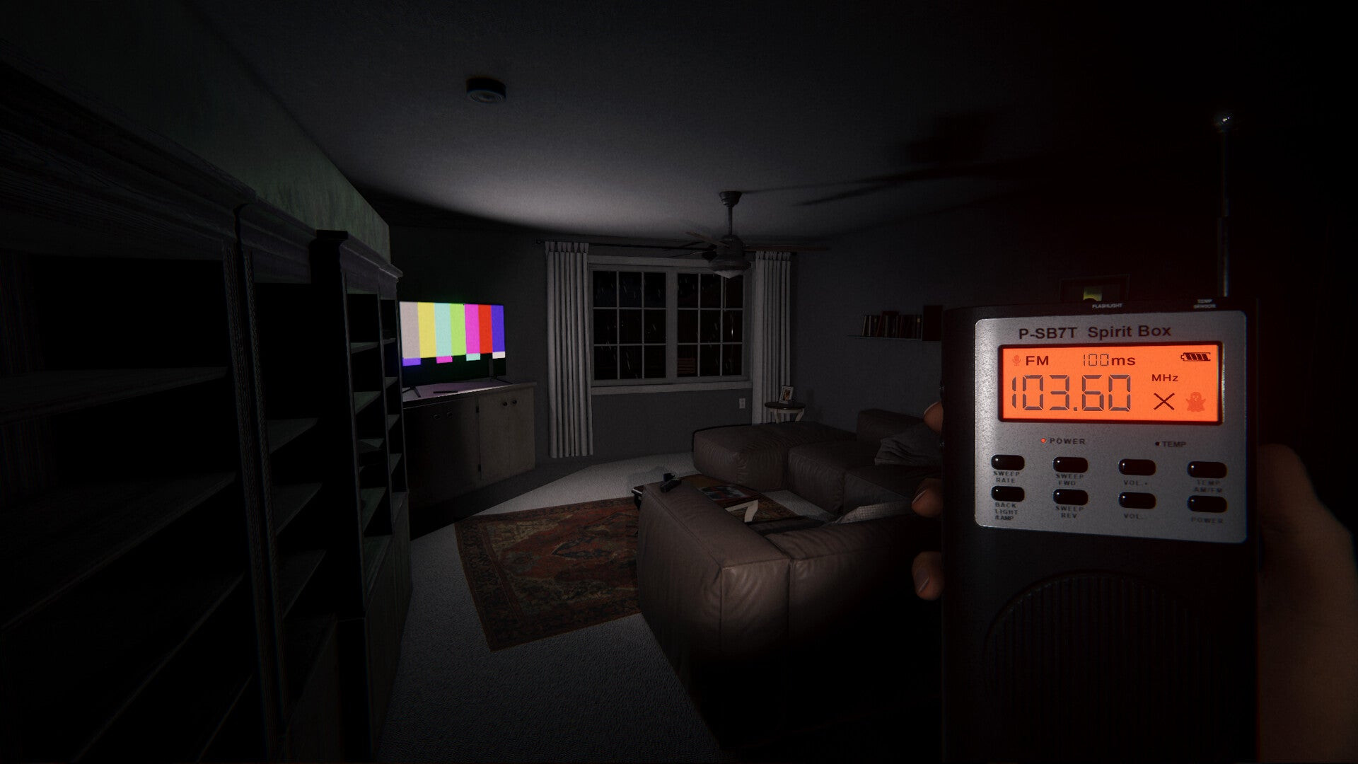 The player holds a Spirit Box in a living room