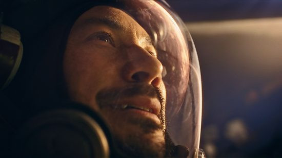 Starfield: Barrett looks out into the atmosphere, with a reflection shining off his space suit helmet, capturing the game's immersive exploration