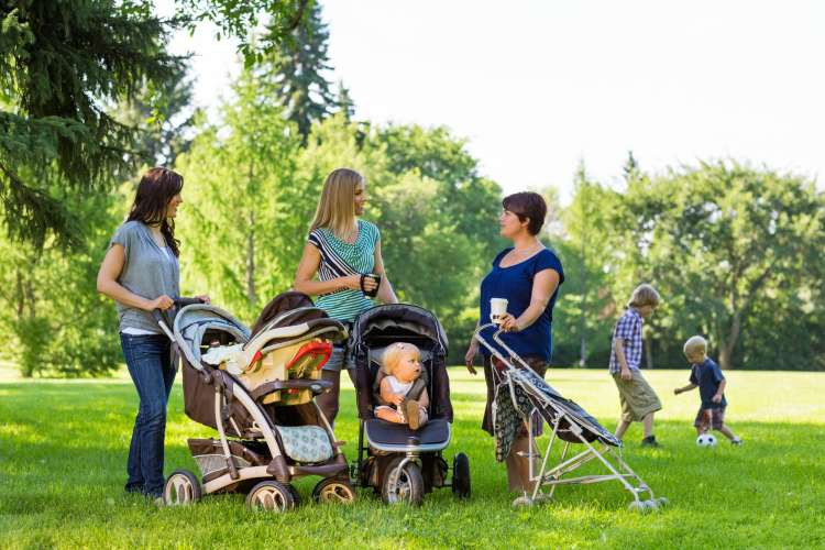 Guests participating in a stroller relay race outdoors