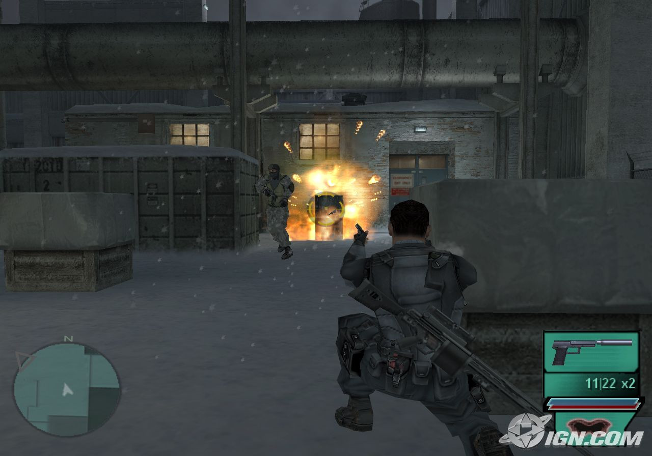 A crouched man shoots a barrel near an enemy and it ignites