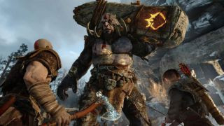 Kratos and Atreus standing before a monster in God of War