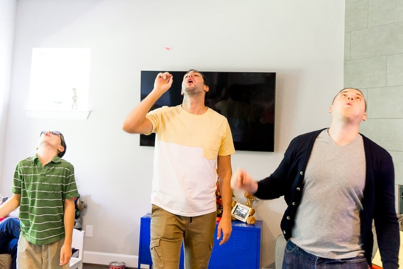 Boys playfully blowing feathers during a Thanksgiving game