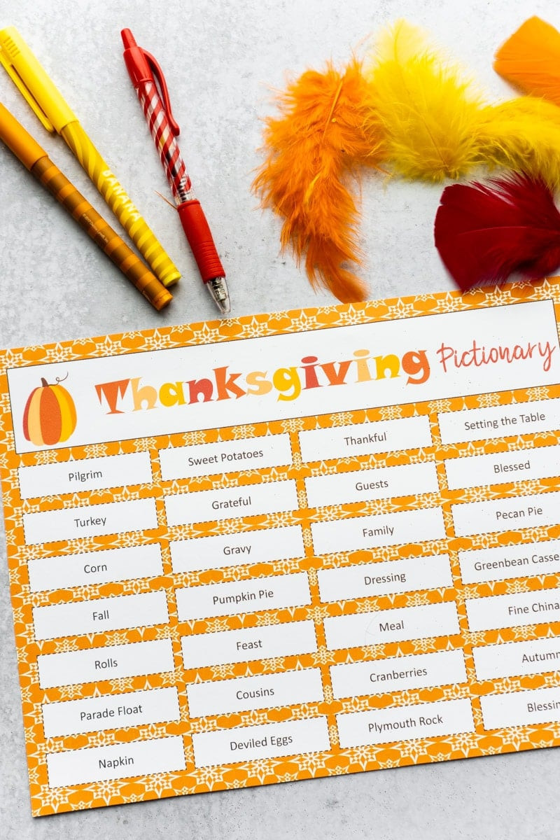 A Pictionary setup with Thanksgiving-themed words and drawing materials
