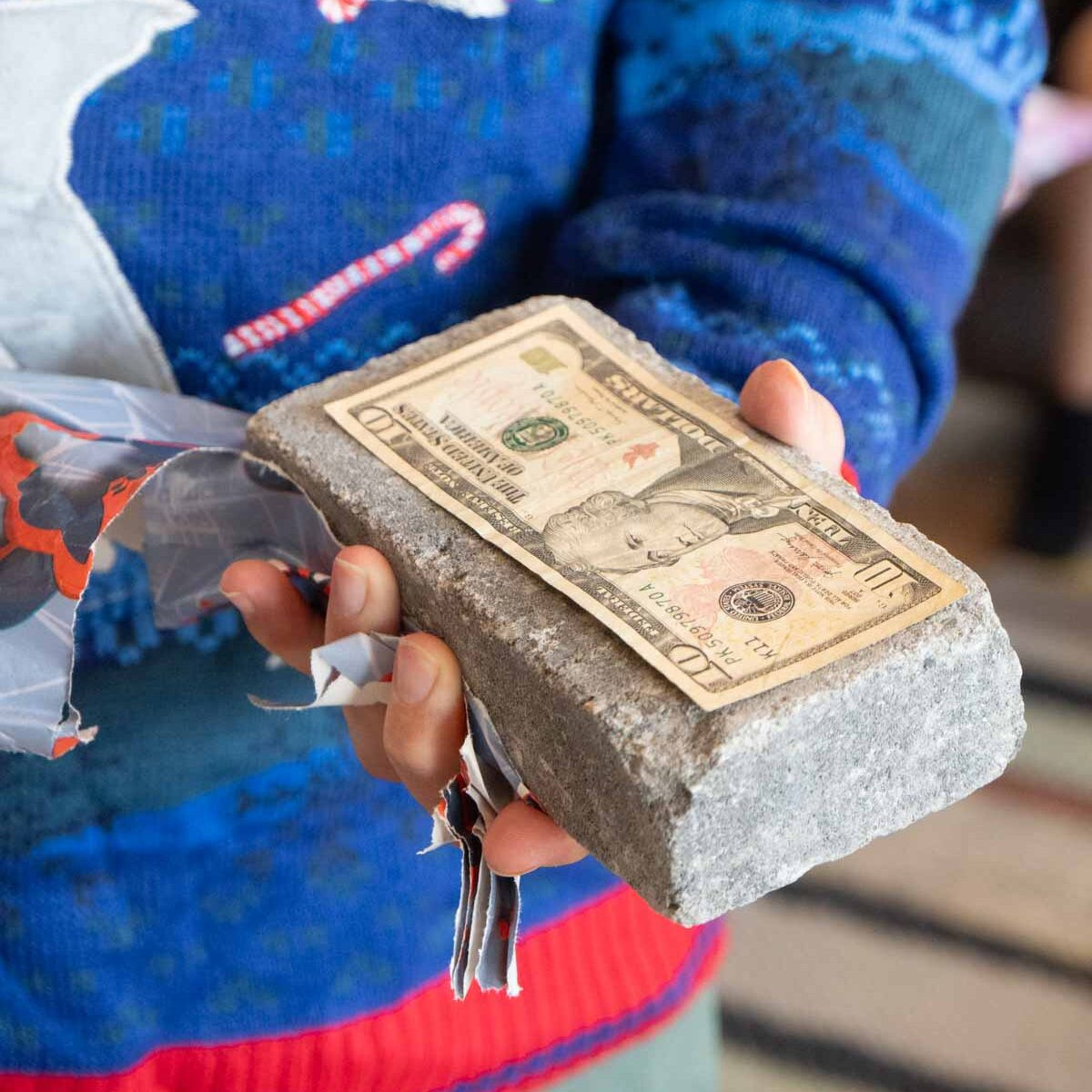 A brick with money taped to one side
