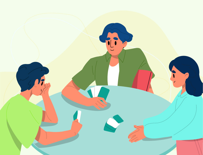 three people playing cards
