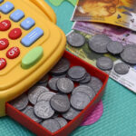 A toy cash register and play money