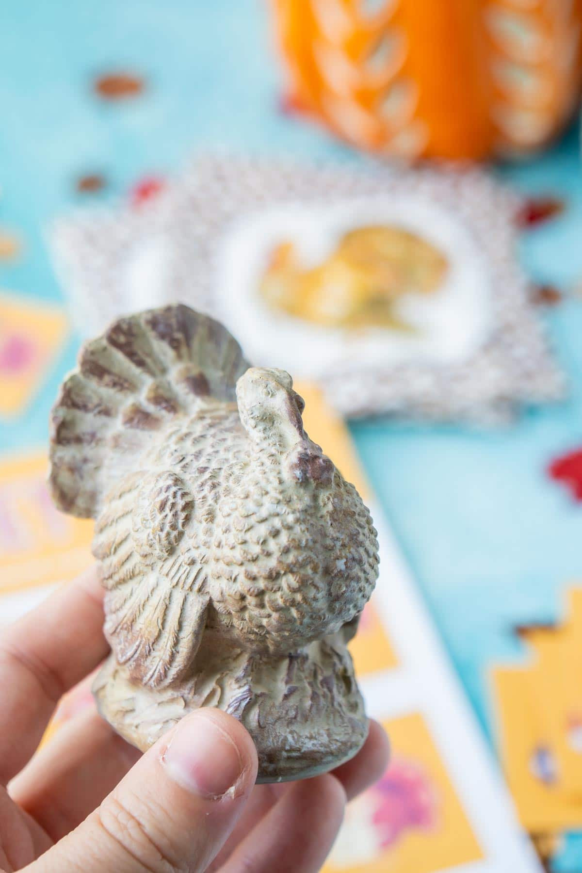 A woman proudly holds a ceramic turkey as part of a 'Turkey Hunt' game
