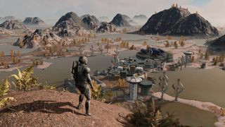 Starfield photo mode screenshot of a person in a space suit standing on a dirt hill, staring out across a small headquarters on an alien planet.