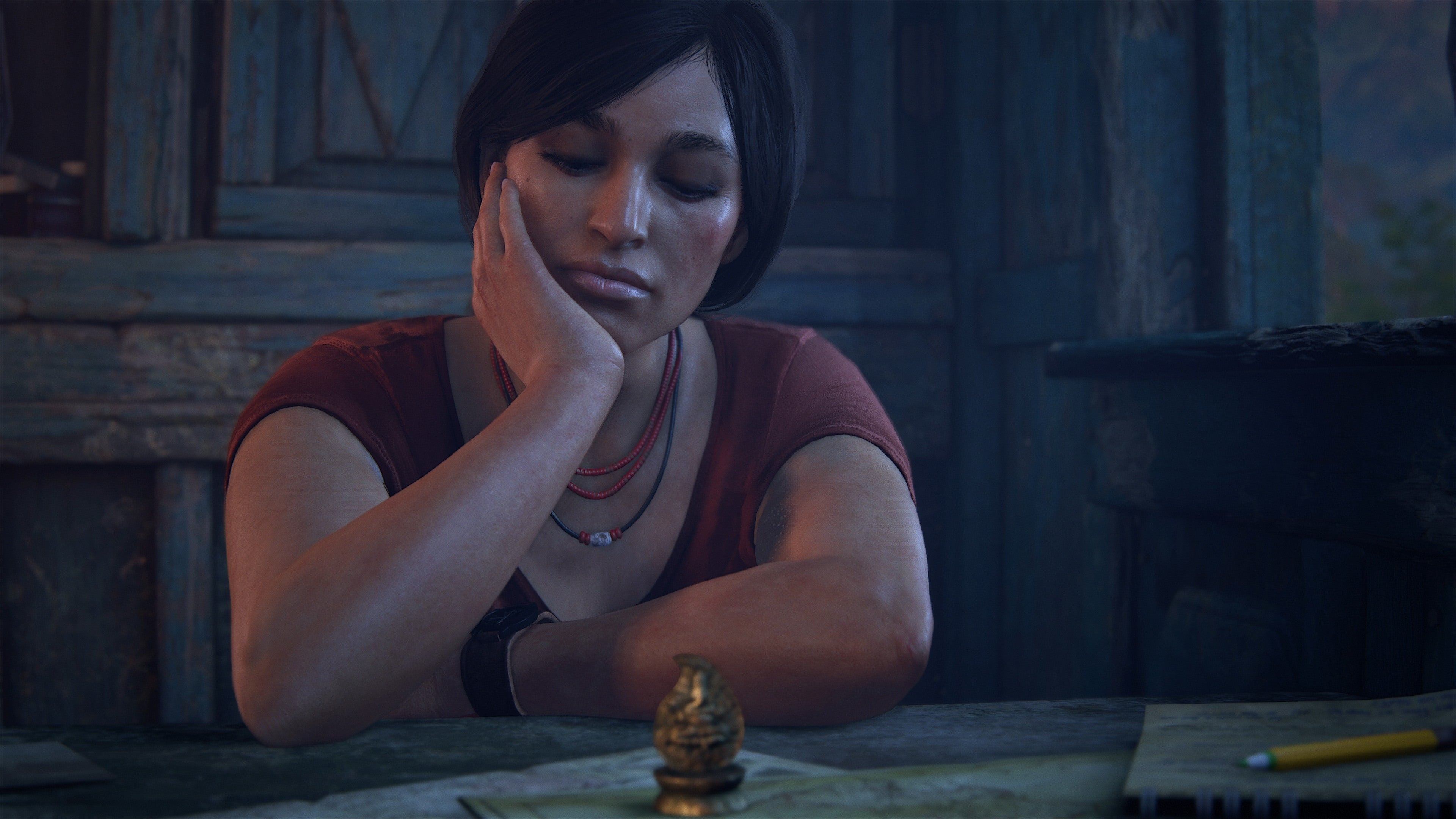 A woman rests her head on her hand