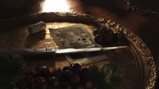 Mafia: The Old Country game screenshot featuring a knife and grapes on a bloody platter.