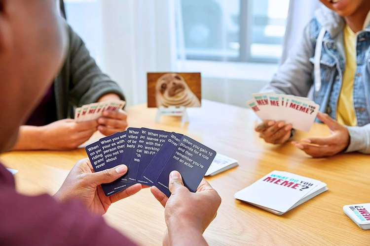 group of friends playing What Do You Meme card game