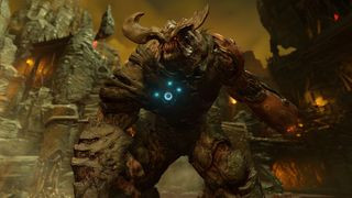 Screenshot from the video game Doom (2016). A giant, horned demon beast is getting ready to strike.